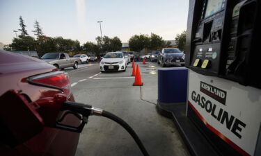 A driver pumps gas at a gas station of Costco in San Leandro