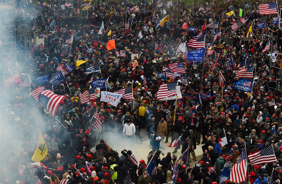 <i>Roberto Schmidt/AFP/Getty Images</i><br/>Trump supporters clash with police and security forces as they storm the US Capitol in Washington D.C on January 6