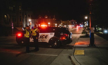 Police and emergency personnel work on a crime scene on November 21