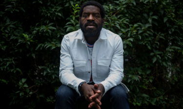 Poet Hanif Abdurraqib sitting for a portrait outside his home in Columbus