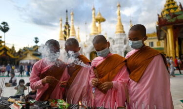 Nuns light incense sticks at Shwedagon Pagoda during the Thadingyut festival.