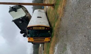 One of the school buses in Trousdale County was flipped over by strong winds and then hit by a 5th-wheel camper on Monday morning.