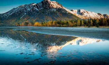 A frozen Kenai Lake reflects Langille Mountain in Alaska in September. With a high of 67 degrees