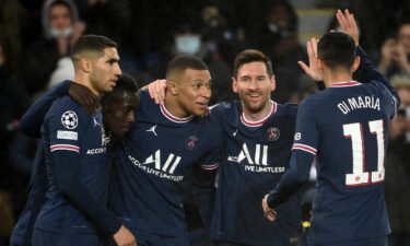 Lionel Messi and Mbappe celebrate with teammates.