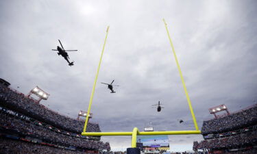 The US military and the Federal Aviation Administration are reviewing a flyover of an NFL game last month to determine if the military helicopters flew too low over civilians in violation of aviation regulations.