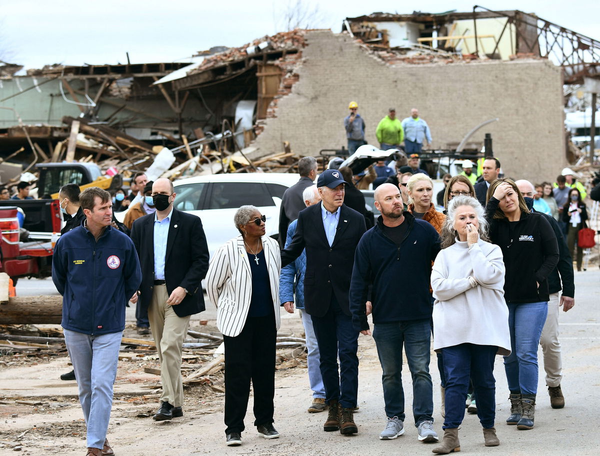 <i>Brendan Smialowski/AFP/Getty Images</i><br/>President Joe Biden (C) tours Mayfield