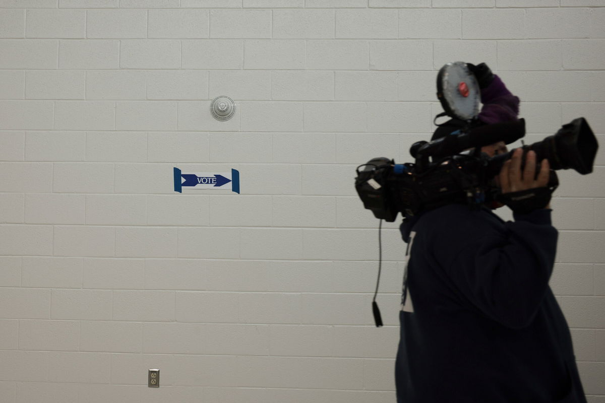 <i>Anna Moneymaker/Getty Images</i><br/>A  man carries a TV camera into a voting location in the Rocky Run Middle School on November 02