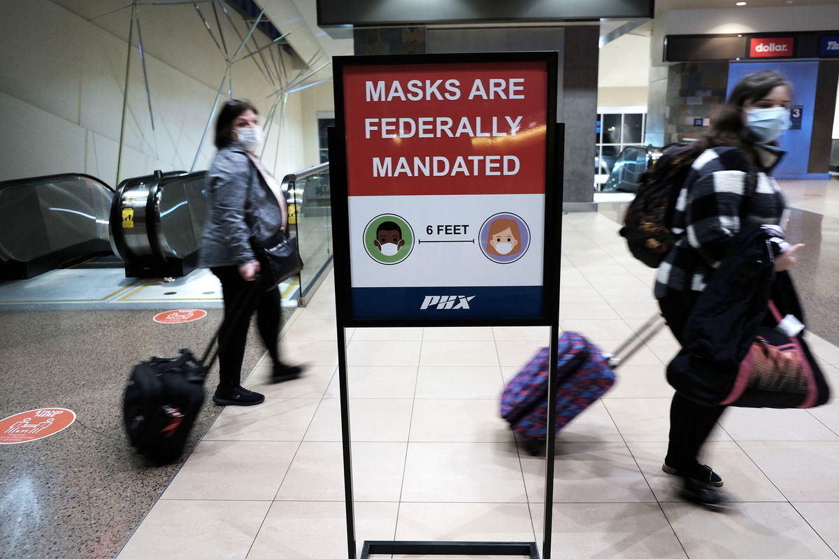 <i>Spencer Platt/Getty Images</i><br/>People walk through Sky Harbor International Airport in Phoenix on December 18. After missing out on holiday gatherings last year