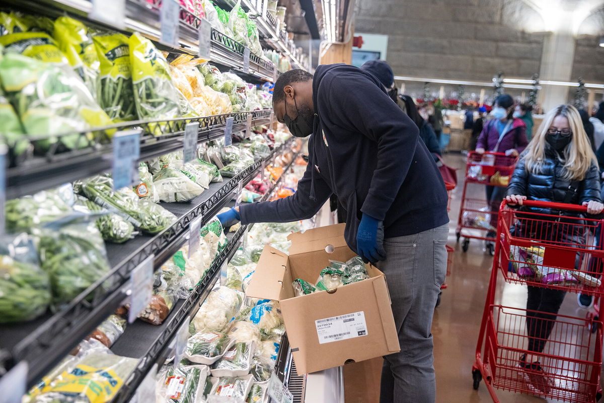 <i>Jeenah Moon/Bloomberg/Getty Images</i><br/>An employee restocks shelves at the Trader Joe's Upper East Side Bridgemarket grocery store in New York