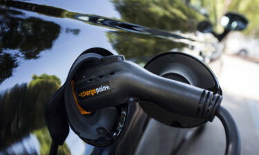 A ChargePoint Inc. charging plug sits connected to an electric vehicle (EV) at a station in Los Angeles.