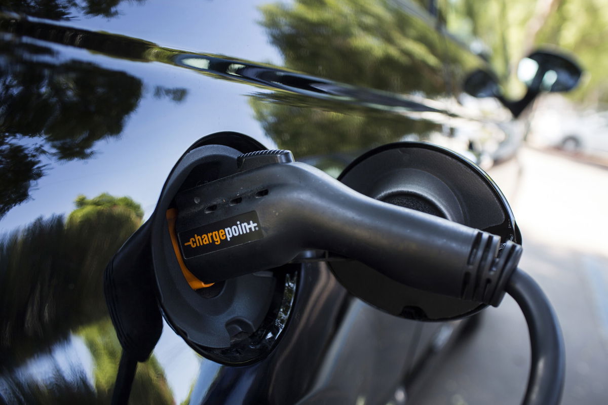 <i>Dania Maxwell/Bloomberg/Getty Images</i><br/>A ChargePoint Inc. charging plug sits connected to an electric vehicle (EV) at a station in Los Angeles.