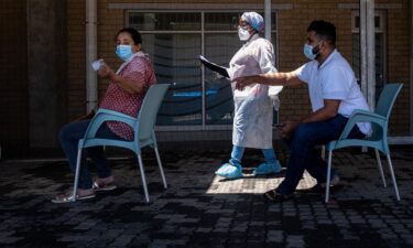 People queue for a PCR Covid-19 test at the Lancet laboratory in Johannesburg on November 30.