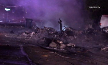 Wreckage of a plane crash covers a street in El Cajon