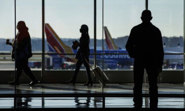 Travelers walk through the concourse at BaltimoreWashington Airport (BWI) in Baltimore