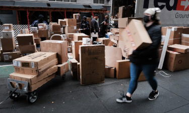 Dozens of packages are lined up along a Manhattan street as a FedEx truck makes deliveries on December 6 in New York City.