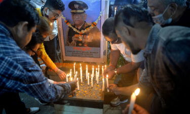 People light candles to pay tribute to India's defense chief Gen. Bipin Rawat