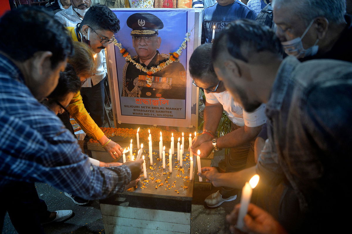 <i>Diptendu Dutta/AFP/Getty Images</i><br/>People light candles to pay tribute to India's defense chief Gen. Bipin Rawat