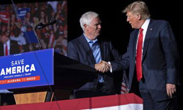 Former President Donald Trump welcomes candidate for Rep. Mo Brooks to the stage during a "Save America" rally at York Family Farms on August 21