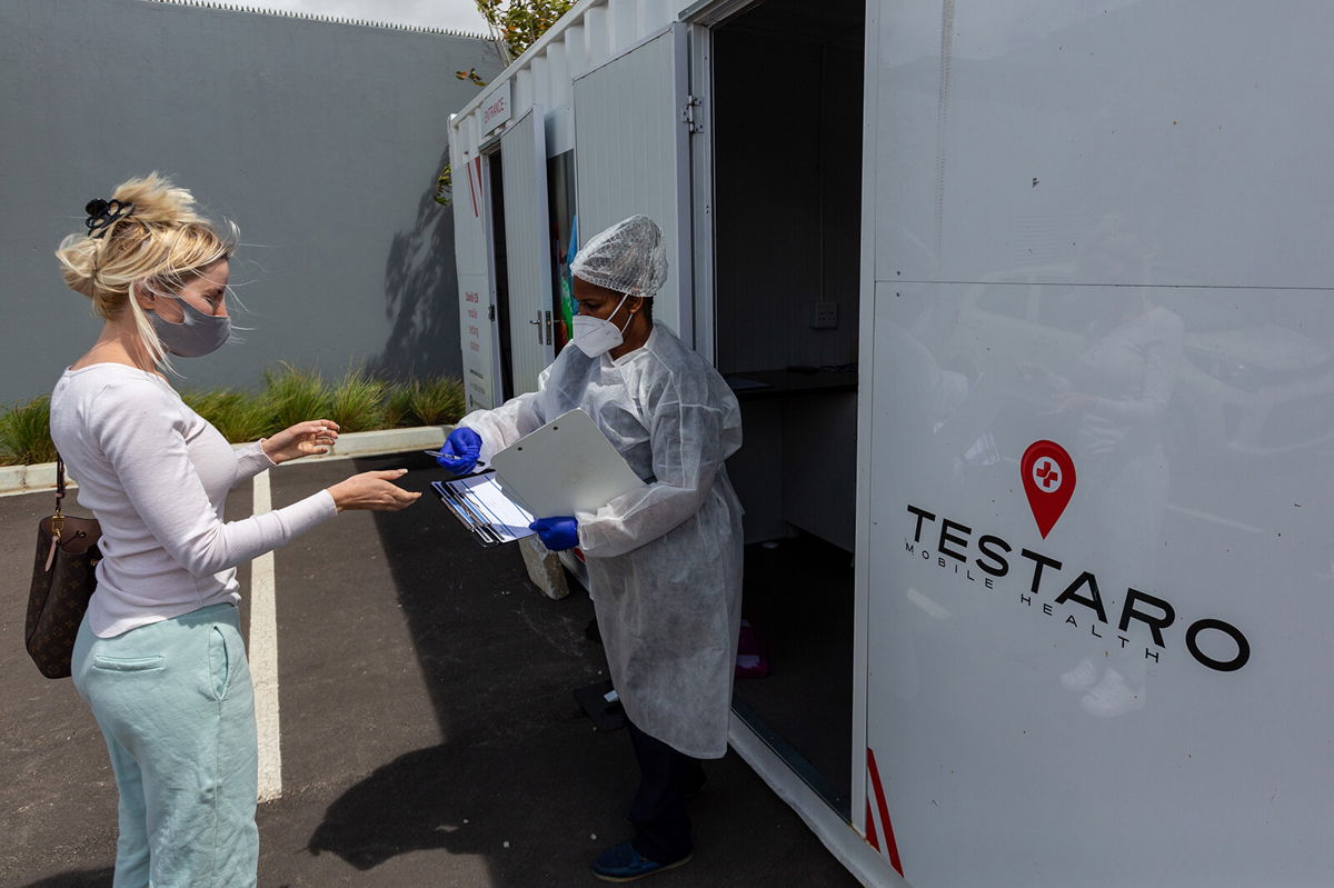 <i>Dwayne Senior/Bloomberg/Getty Images</i><br/>A resident registers her details at a Covid-19 mobile testing site in the Milnerton district of Cape Town