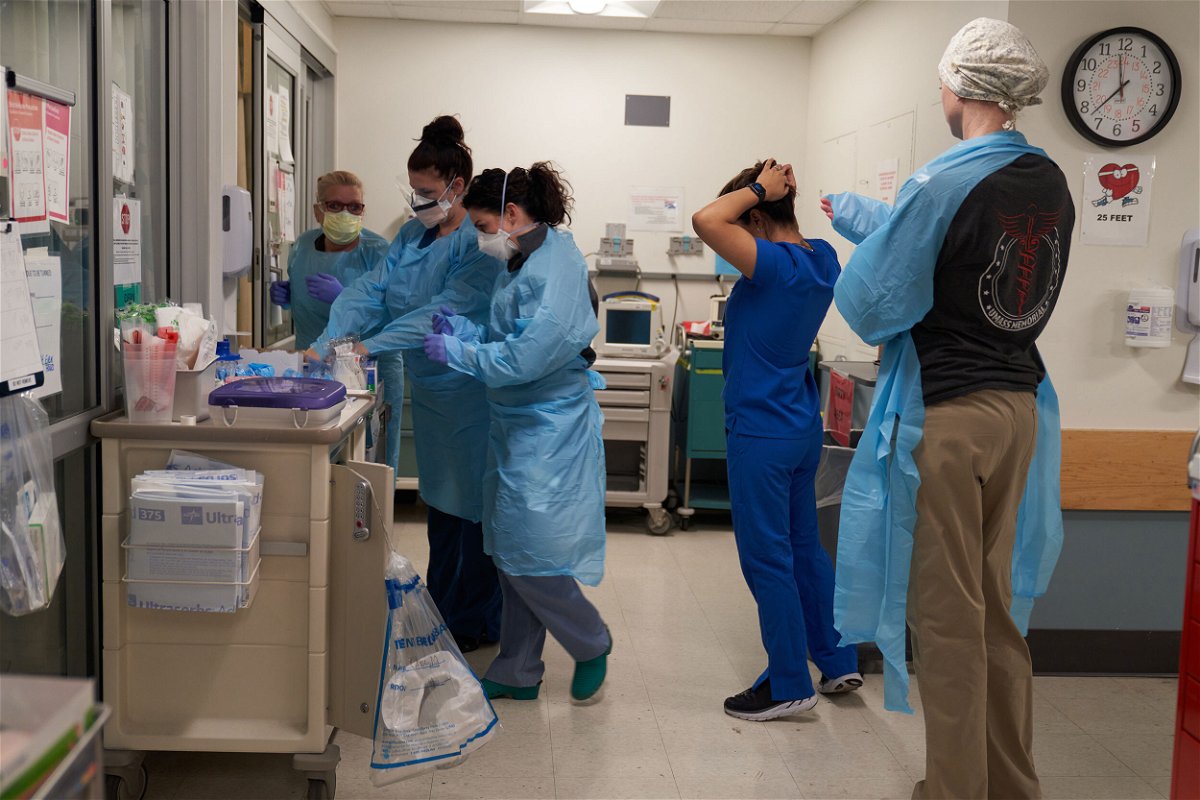 <i>Allison Dinner/Bloomberg/Getty Images</i><br/>Healthcare workers put on PPE on the Covid-19 ICU floor of the University of Massachusetts (UMass) Memorial Hospital in Worcester