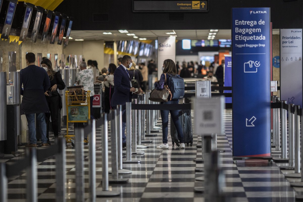 <i>Victor Moriyama/Bloomberg via Getty Images</i><br/>Travelers check-in at Congonhas Airport  in Sao Paulo
