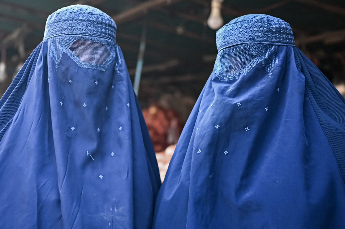 <i>Mohd Rasfan/AFP/Getty Images</i><br/>Afghan women are seen at a market in Kabul on December 20.