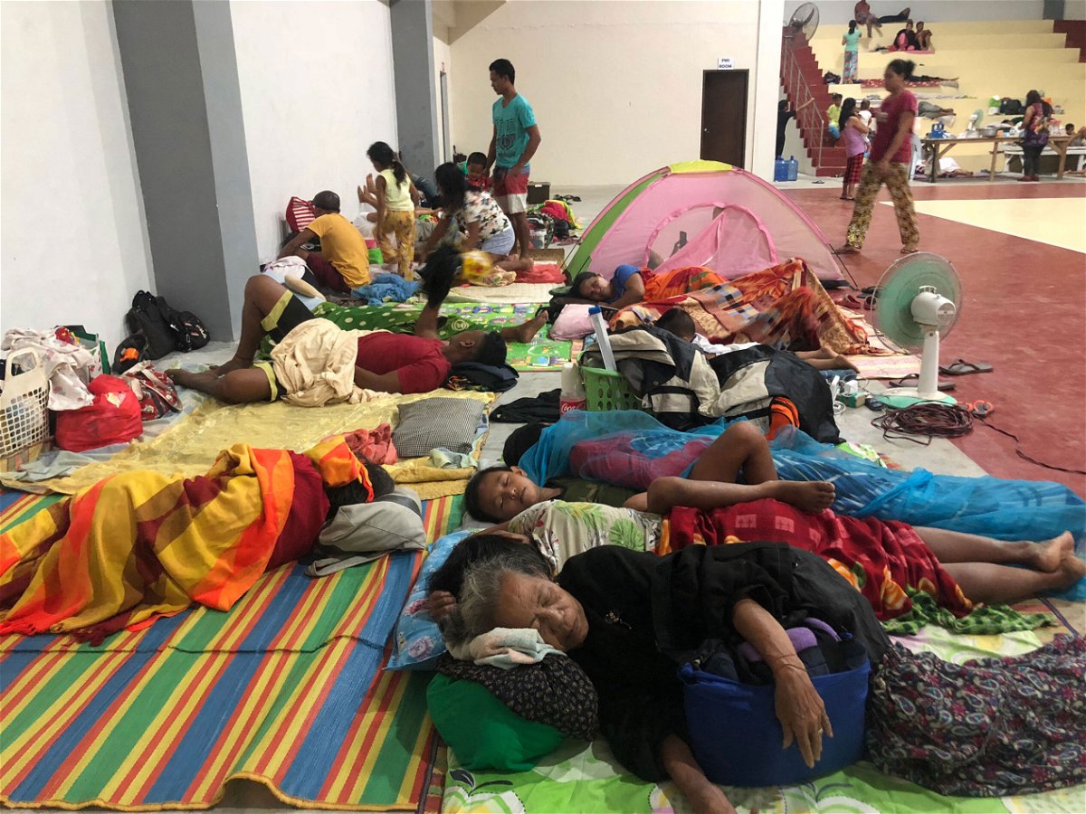<i>Roel Catoto//AFP/Getty Images</i><br/>Residents sleep inside a sports complex turned into an evacuation center in Dapa town
