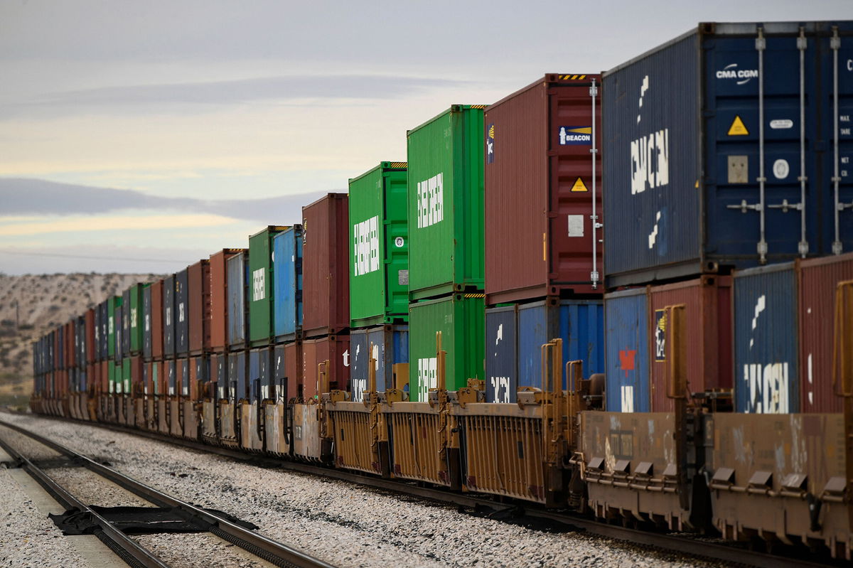 <i>Patrick T. Fallon/AFP/Getty Images</i><br/>A freight train carries cargo shipping containers in the El Paso Sector along the US-Mexico border between New Mexico and Chihuahua state on December 9 in Sunland Park