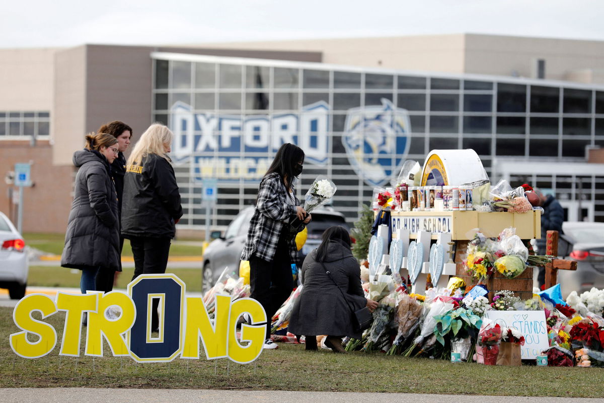 <i>Jeff Kowalsky/AFP/Getty Images</i><br/>People gather at the memorial for the dead and wounded outside of Oxford High School in Oxford