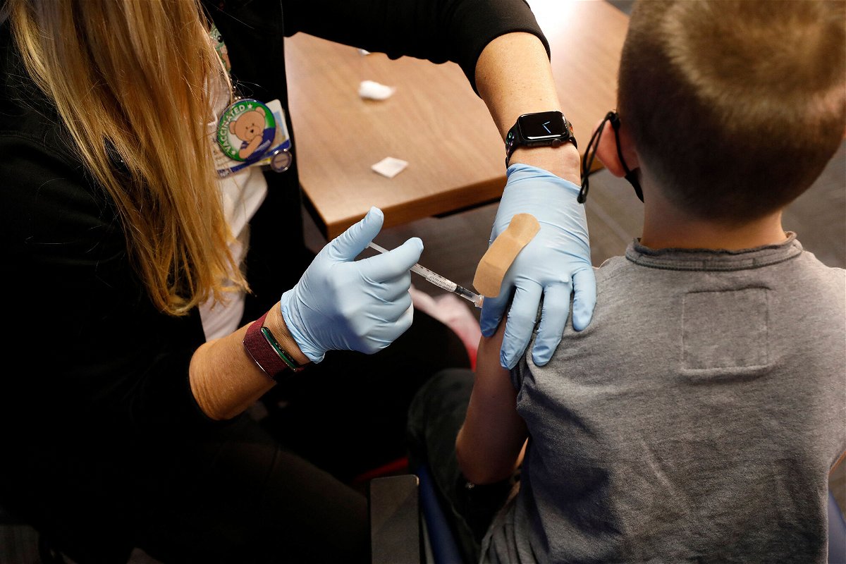 <i>Jeff Kowalsky/AFP/Getty Images</i><br/>A 8 year-old child receives their first dose of the Pfizer Covid-19 vaccine at the Beaumont Health offices in Southfield
