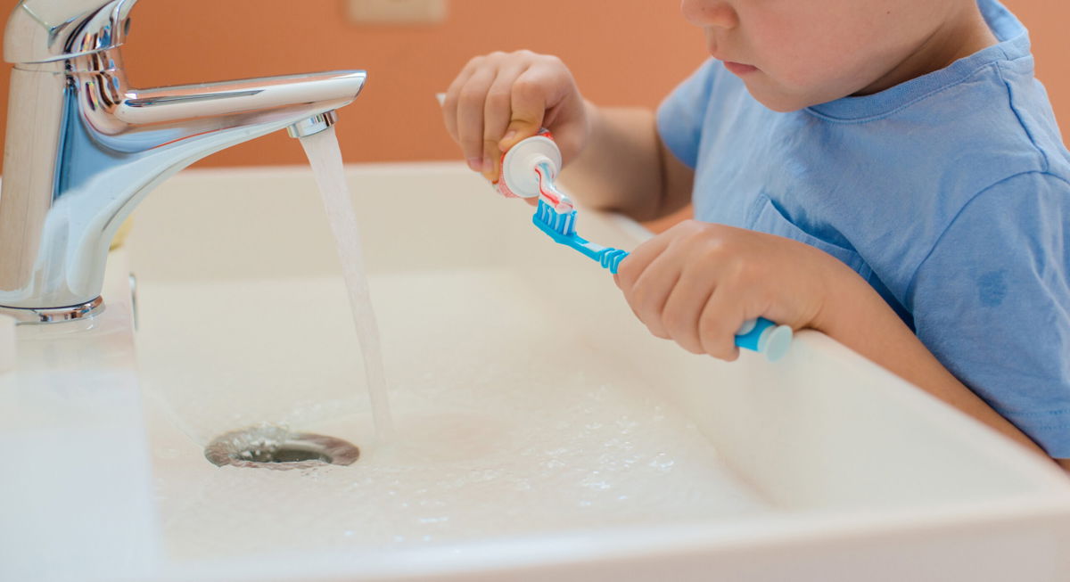<i>Shangarey Julia/Adobe Stock</i><br/>A child brushes his teeth in the bathroom.