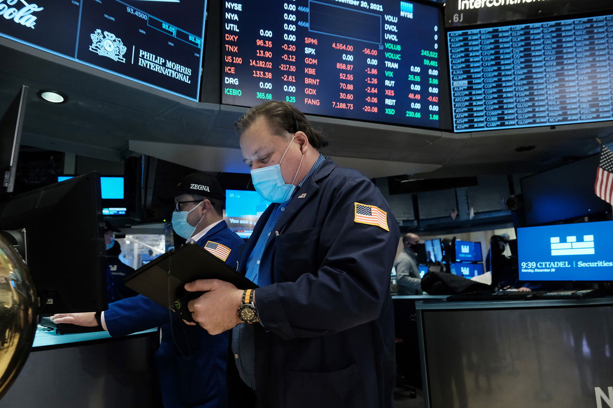 <i>Spencer Platt/Getty Images</i><br/>A trader works on the floor of the New York Stock Exchange at the start of trading on December 20 following a steep decline in global stocks over fears of the new Omicron COVID variant.