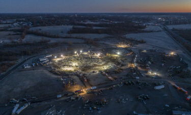 Workers at the Mayfield Consumer Products candle factory file a lawsuit against the employer. Pictured are search and rescue teams at the candle factory early December 12.