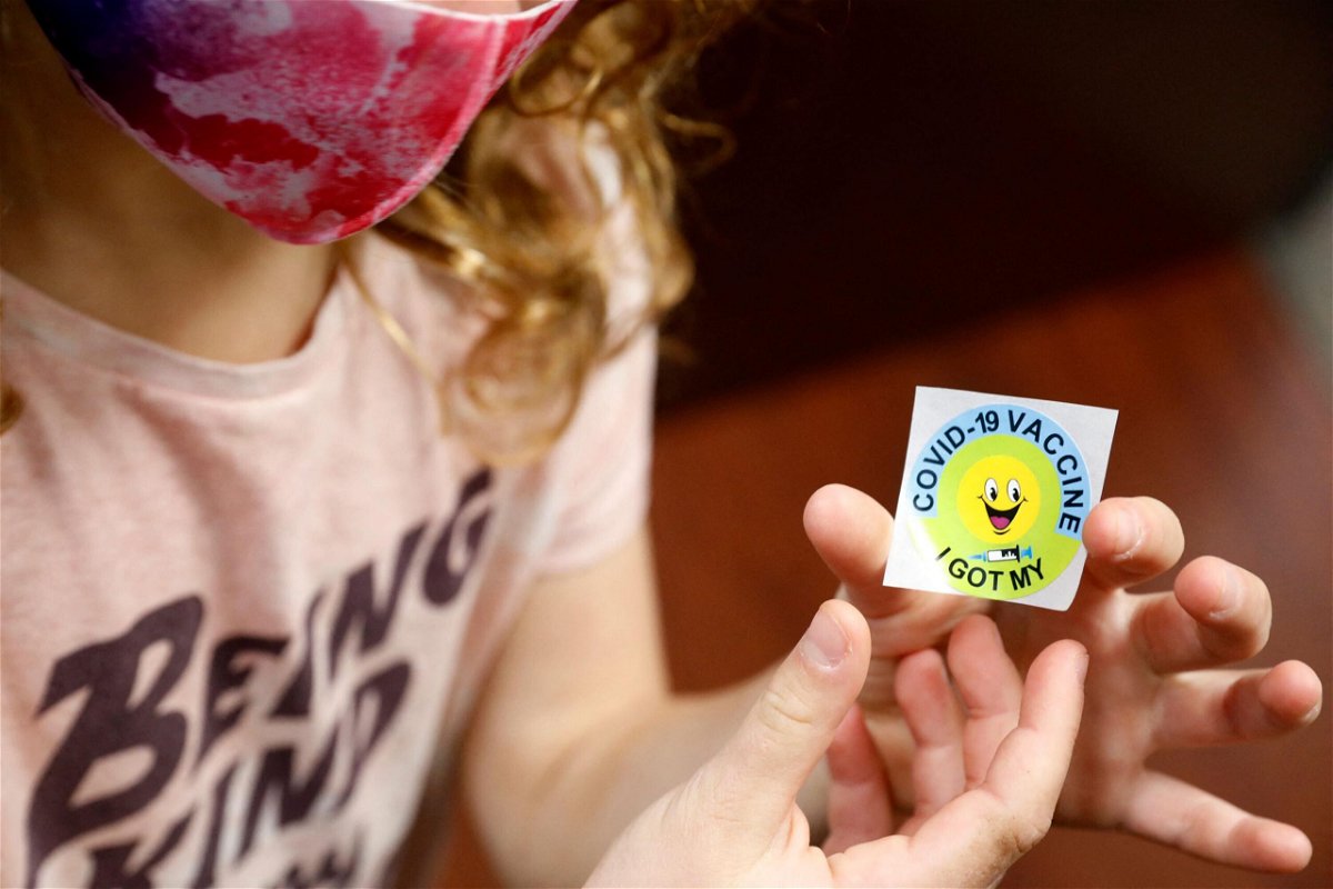 <i>JEFF KOWALSKY/AFP/Getty Images</i><br/>A 7 year-old child holds a sticker she received after getting the Pfizer-BioNTech Covid-19 vaccine at the Child Health Associates office in Novi