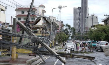 Toppled electrical posts lie along a street in Cebu city