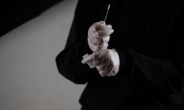 A healthcare worker prepares a swab test at Covid-19 testing site in Farmington Hills