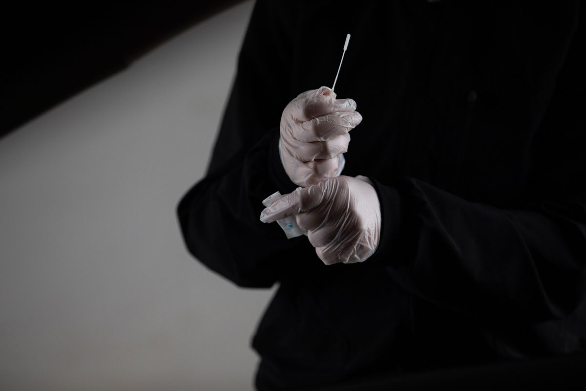 <i>Emily Elconin/Bloomberg/Getty Images</i><br/>A healthcare worker prepares a swab test at Covid-19 testing site in Farmington Hills