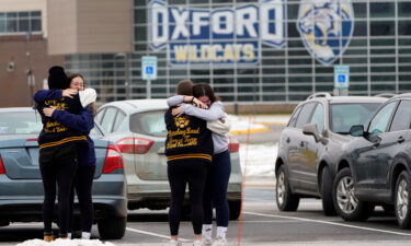 Students hug outside Oxford High School in Oxford