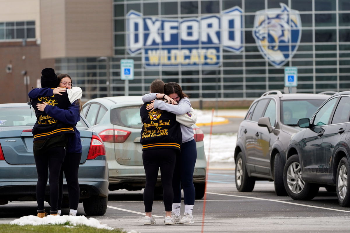 <i>Paul Sancya/AP</i><br/>Students hug outside Oxford High School in Oxford