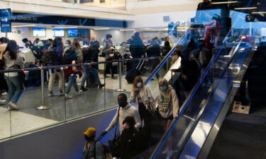 Travelers crowd the United Airlines check-in area at the Los Angeles International Airport on Wednesday