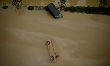 Cars sit in floodwaters following heavy rain in Zhengzhou in China's central Henan province on July 22.