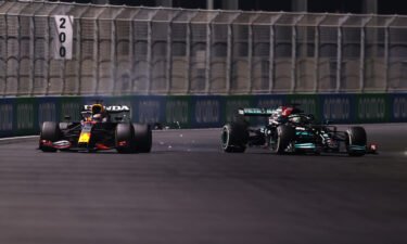 Max Verstappen of the Netherlands driving the (33) Red Bull Racing RB16B Honda and Lewis Hamilton of Great Britain driving the (44) Mercedes AMG Petronas F1 Team Mercedes W12 collide during the F1 Grand Prix of Saudi Arabia at Jeddah Corniche Circuit on December 05