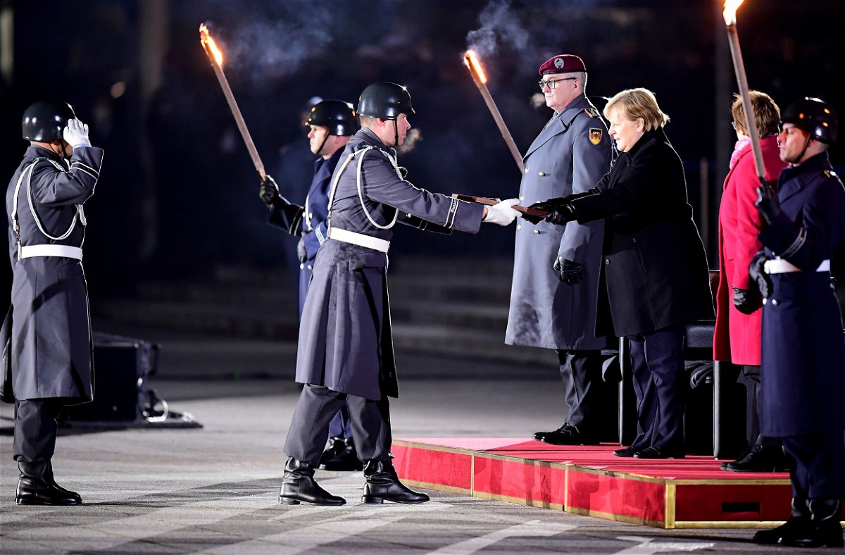 <i>Friedemann Vogel/EPA-EFE/ddp images/Sipa USA</i><br/>Outgoing German Chancellor Angela Merkel is honored at the Grosser Zapfenstreich