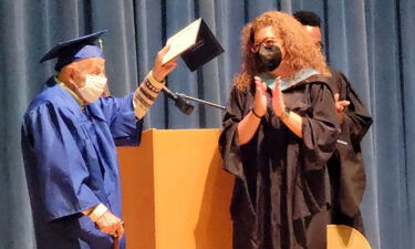 Ernie Reda receives his high school diploma from Stadium High School's principal