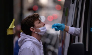 A man receives a nasal swab during a test for Covid-19 at a street-side testing booth in New York on December 17.