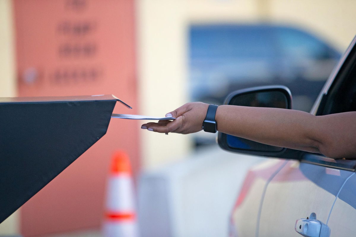 <i>David Santiago/Miami Herald/AP</i><br/>A Broward County resident deposits a ballot at the official dropbox during the 2020 election on November 3