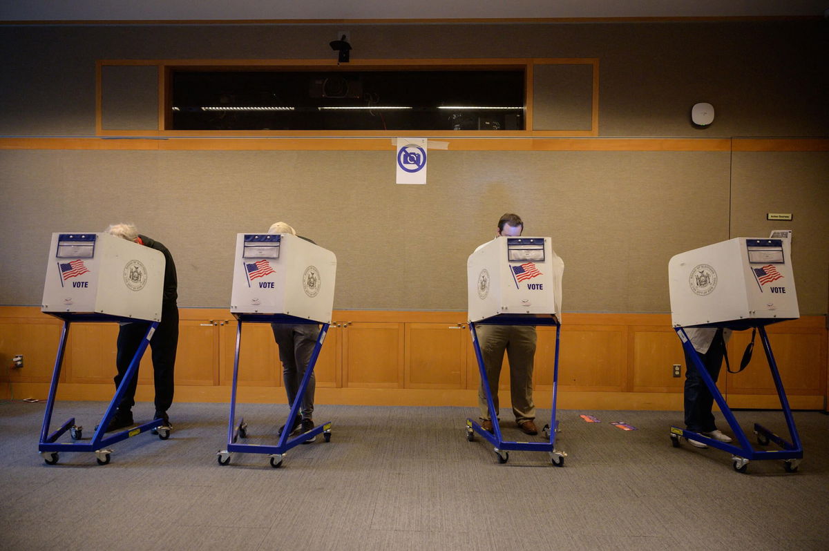 <i>ED JONES/AFP/Getty Images</i><br/>Voters stand in booths at a voting station at the Metropolitan Museum of Art (MET) during the mayoral election process in New York on June 12.