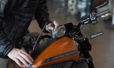 A charger is plugged into a LiveWire electric motorcycle at a Harley-Davidson showroom and repair shop in Lindon