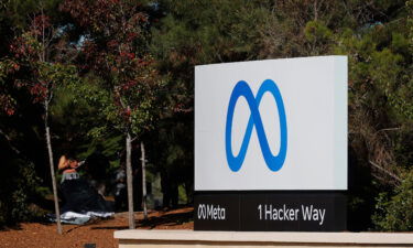 A sign with a new logo and the name 'Meta' is displayed in front of Facebook headquarters on October 28