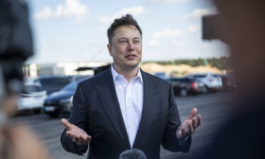 Tesla head Elon Musk talks to the press as he arrives to to have a look at the construction site of the new Tesla Gigafactory near Berlin on September 03